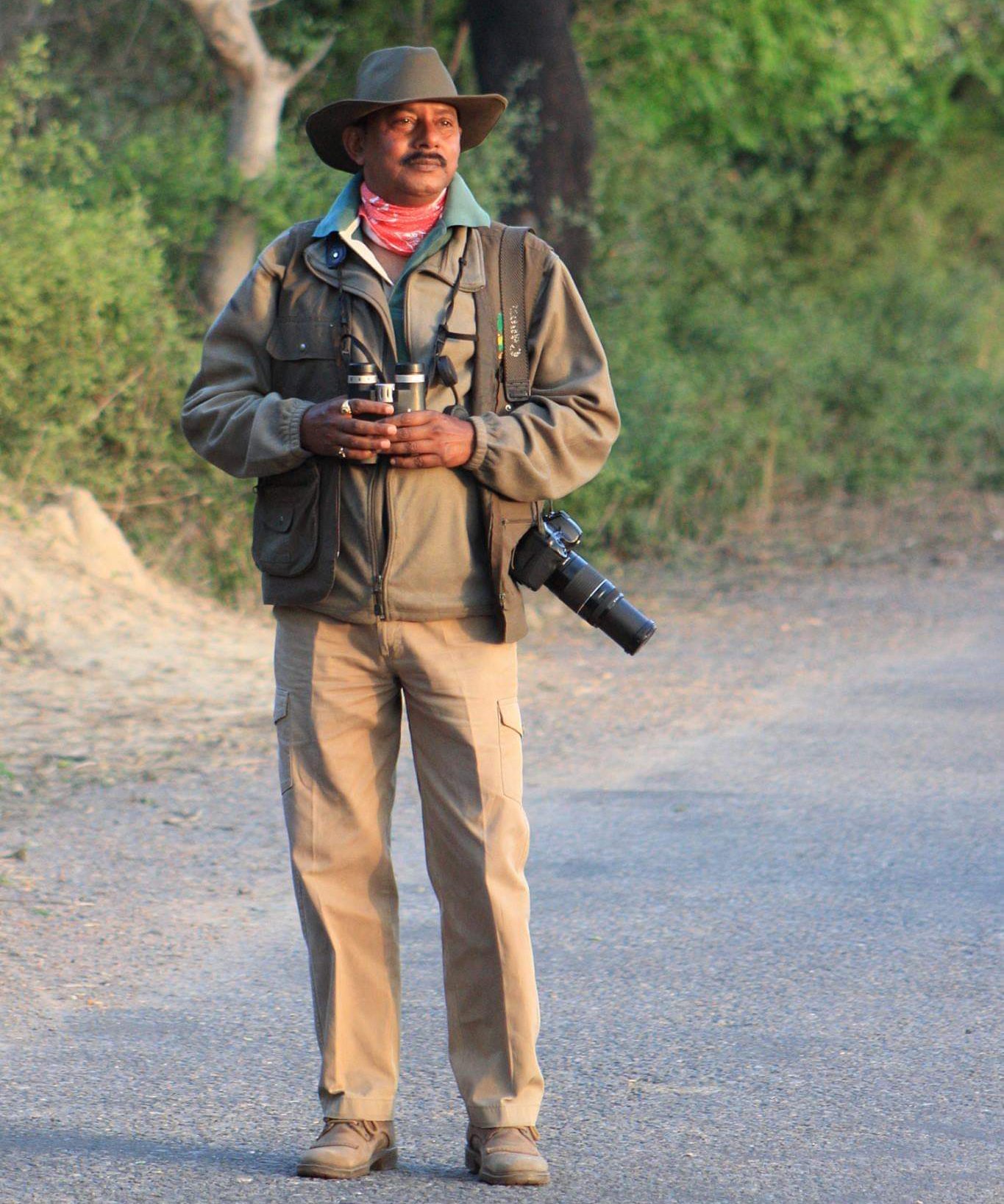 Founder Rakesh Sharma in the field with binoculars